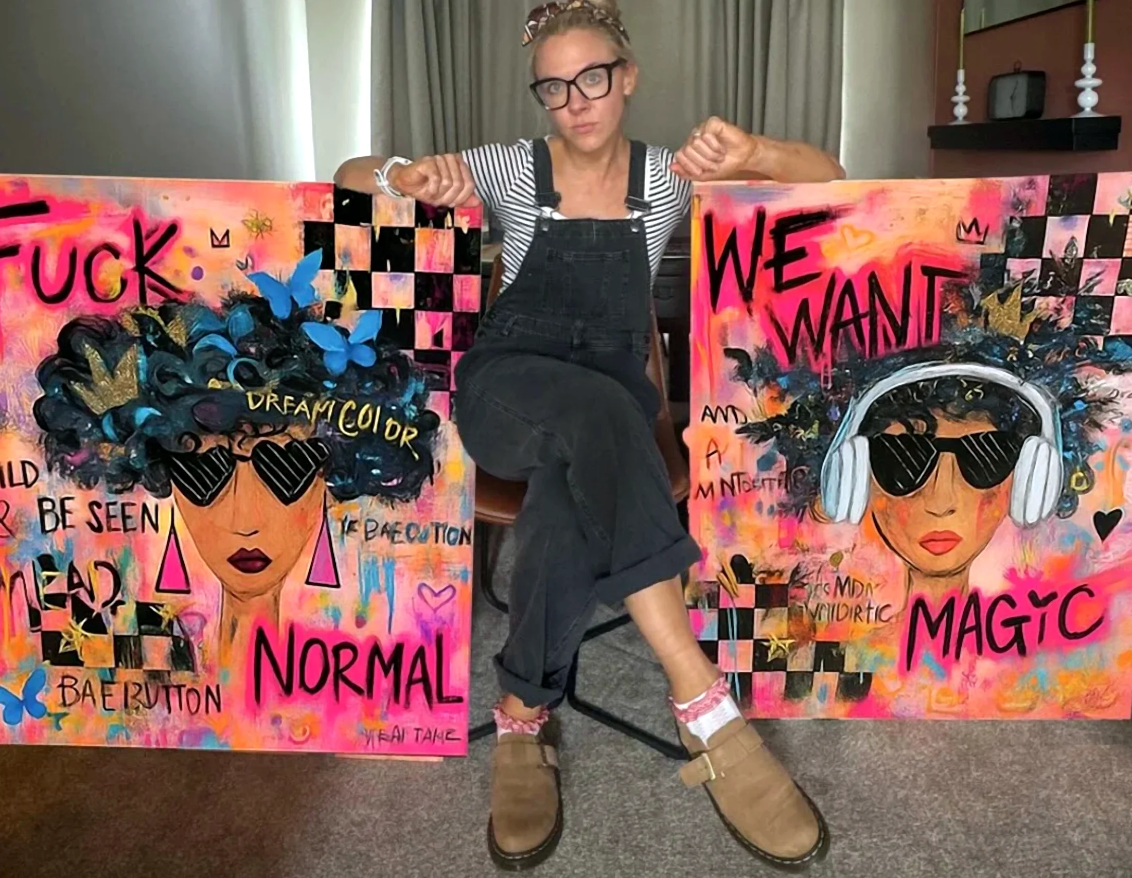 Rach sitting between two of her canvases