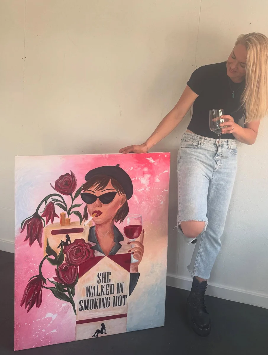 Rach holding her painting She Walked In Smoking Hot